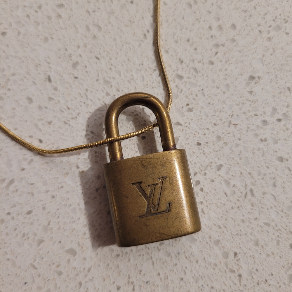 #319 Louis Vuitton Gold Padlock